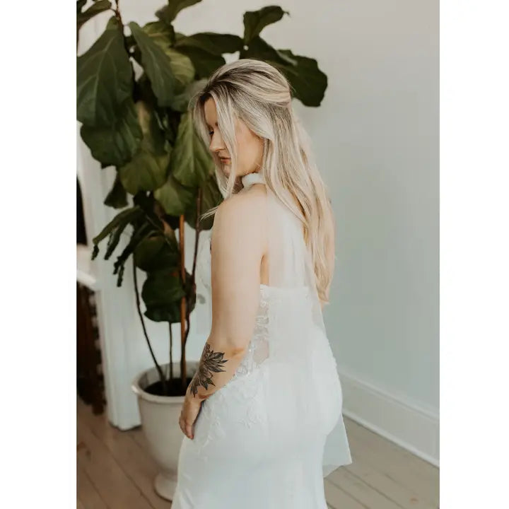 Model in a wedding dress wearing as a scarf