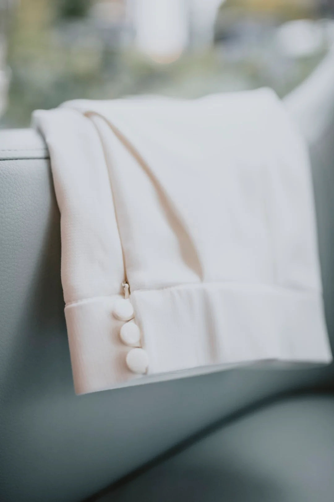 White jac pant outfit with buttons on a blurred background