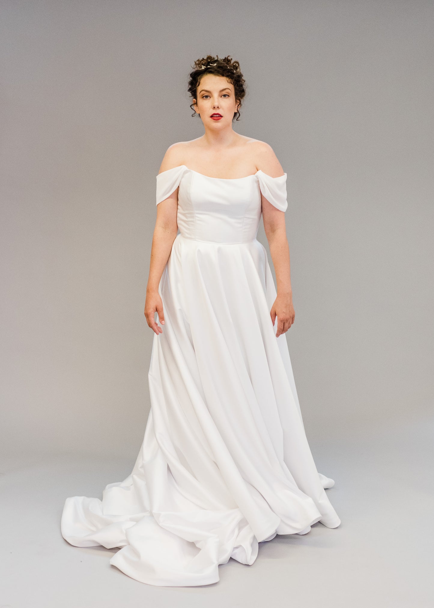 Aline Mikado simple wedding dress shown with Poppy soft off the shoulder drapes
