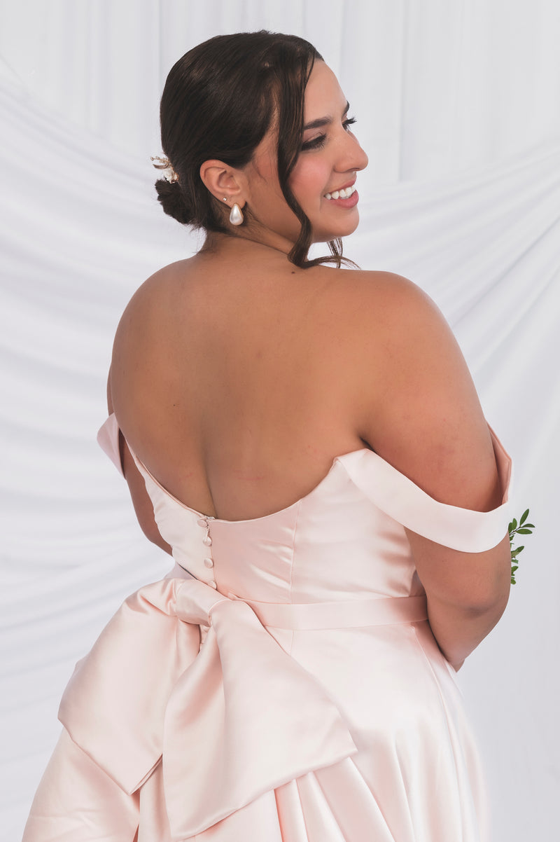 Back View of the Plus Size Wedding Dress with a scooped backline and an oversized bow with satin matching buttons