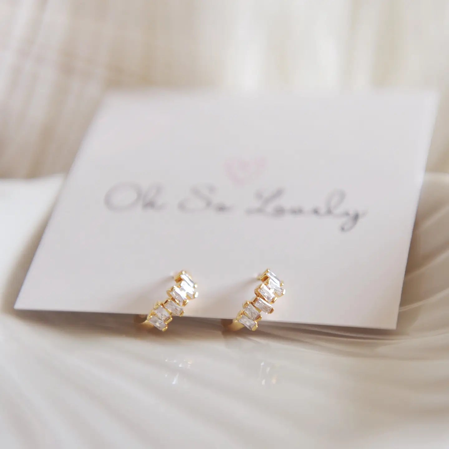 Sunny Huggie Hoops - gold mini hoops on a jewelry back drop
