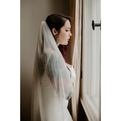Model wearing the pleated light ivory veil