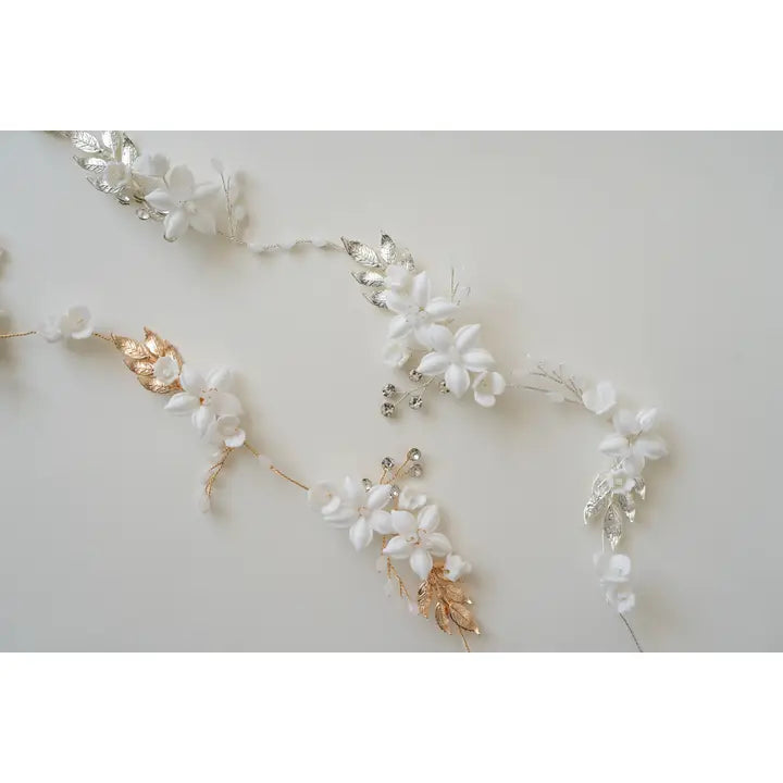 The Eliana hair vine with porcelain flowers, branches in a rose gold and silver.