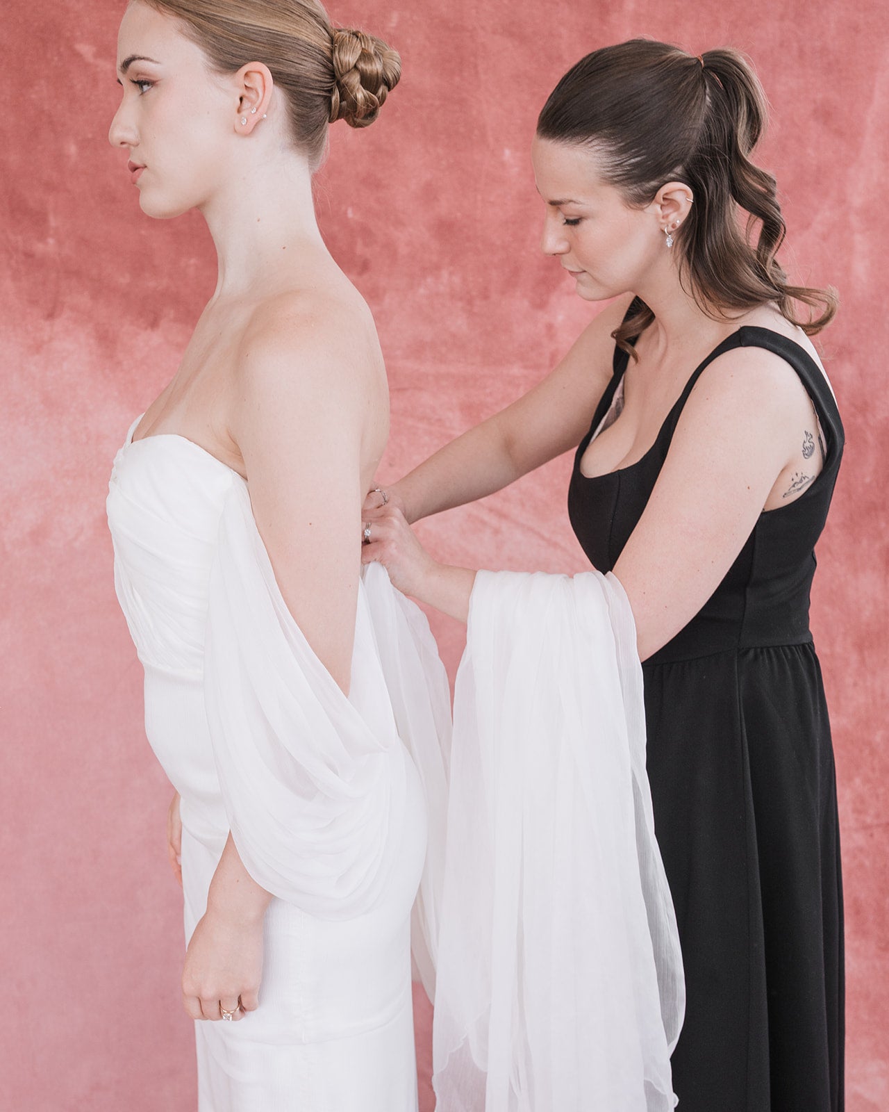 about alway knew, wedding dress shopping ottawa owner zipping up a strapless wedding dres