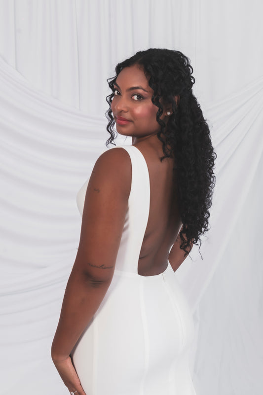 Bride showing off the backless Clara wedding dress, square backline and thick crepe straps.