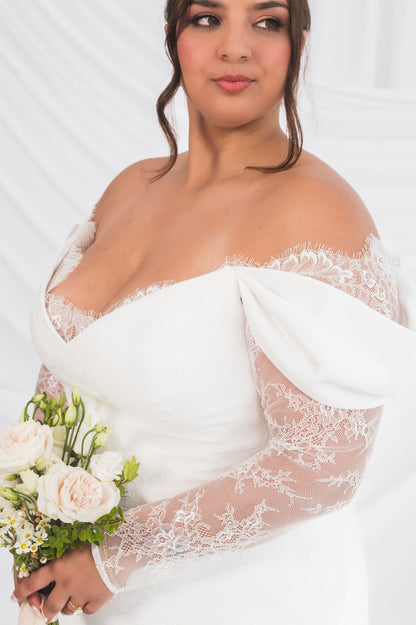Closeup of the jane/vicki wedding dress with an eyelash french lace chantilly lace, v neck. 