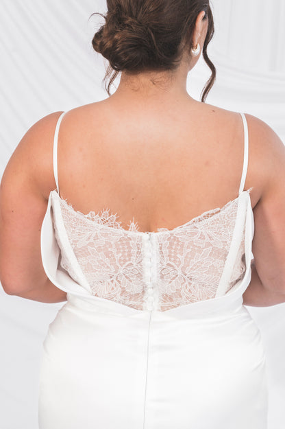 Closeup of the ariel Tessa back with matching matte satin buttons and narrow satin straps. 