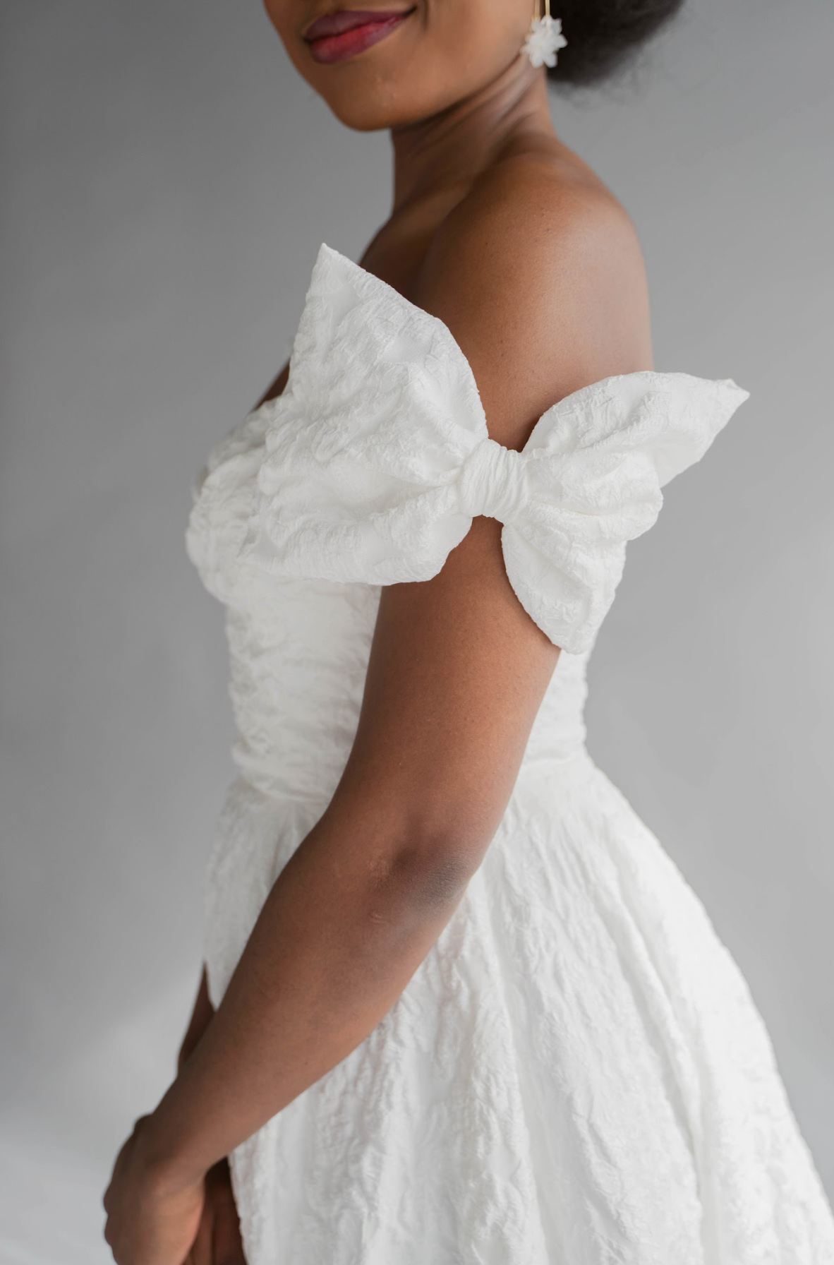Closeup of the Bow Jacquard Add on to the Lauren textured gown