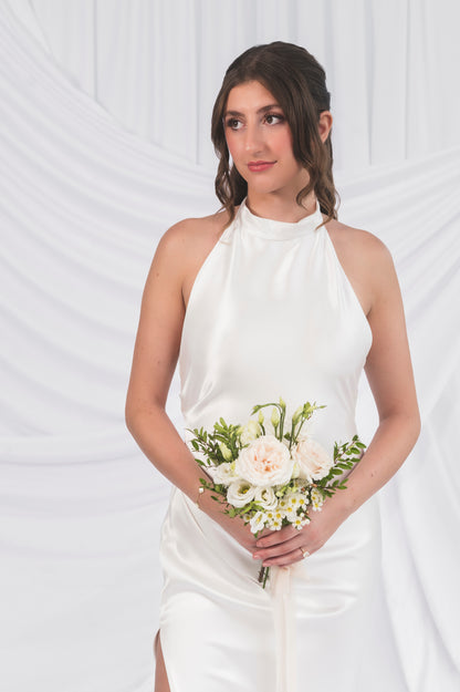 High neck wedding dress with satin, closeup of the bodice. Swoopy bodice with a high leg slit