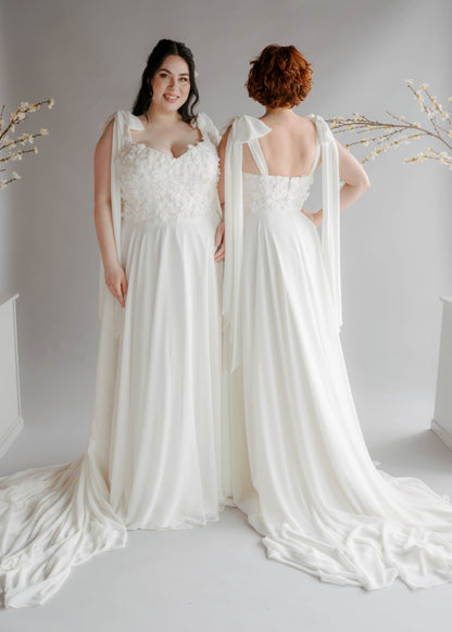 The dahlia shown by 2 models in the front and back