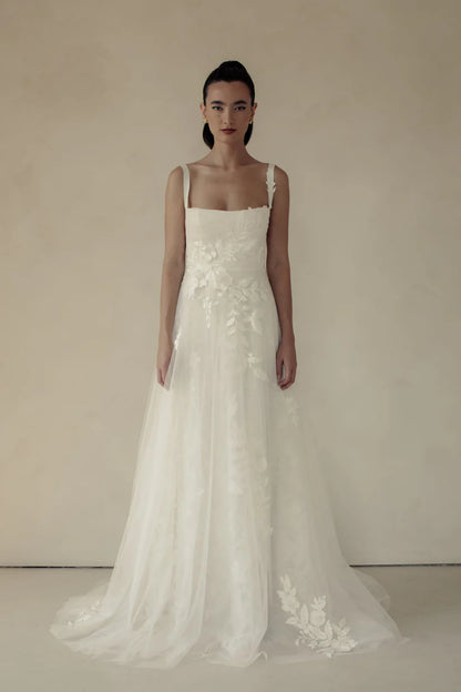 Gia, a flowy A-line gown with asymmetrical lace placement and squared neckline.&nbsp; A structured bodice with grosgrain straps features mesh paneling to enhance shape and style.