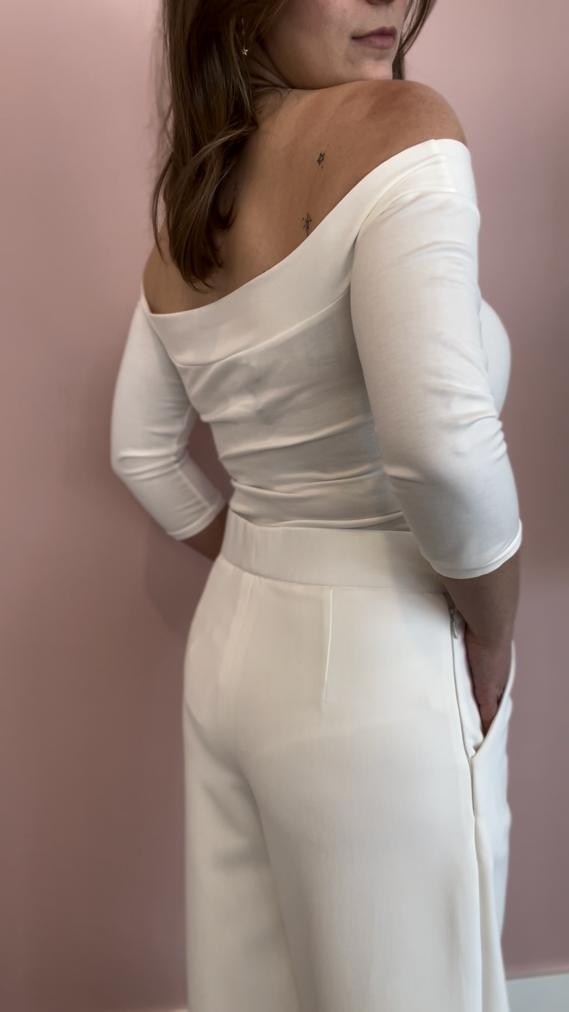 White outfit with sheer sleeves on a plain background