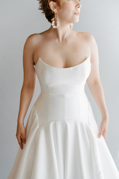 Close up front view of the Lauralie in mikado silk white. Cat eye scooped neckline with a fitted boned bodice and large skirt and long train 