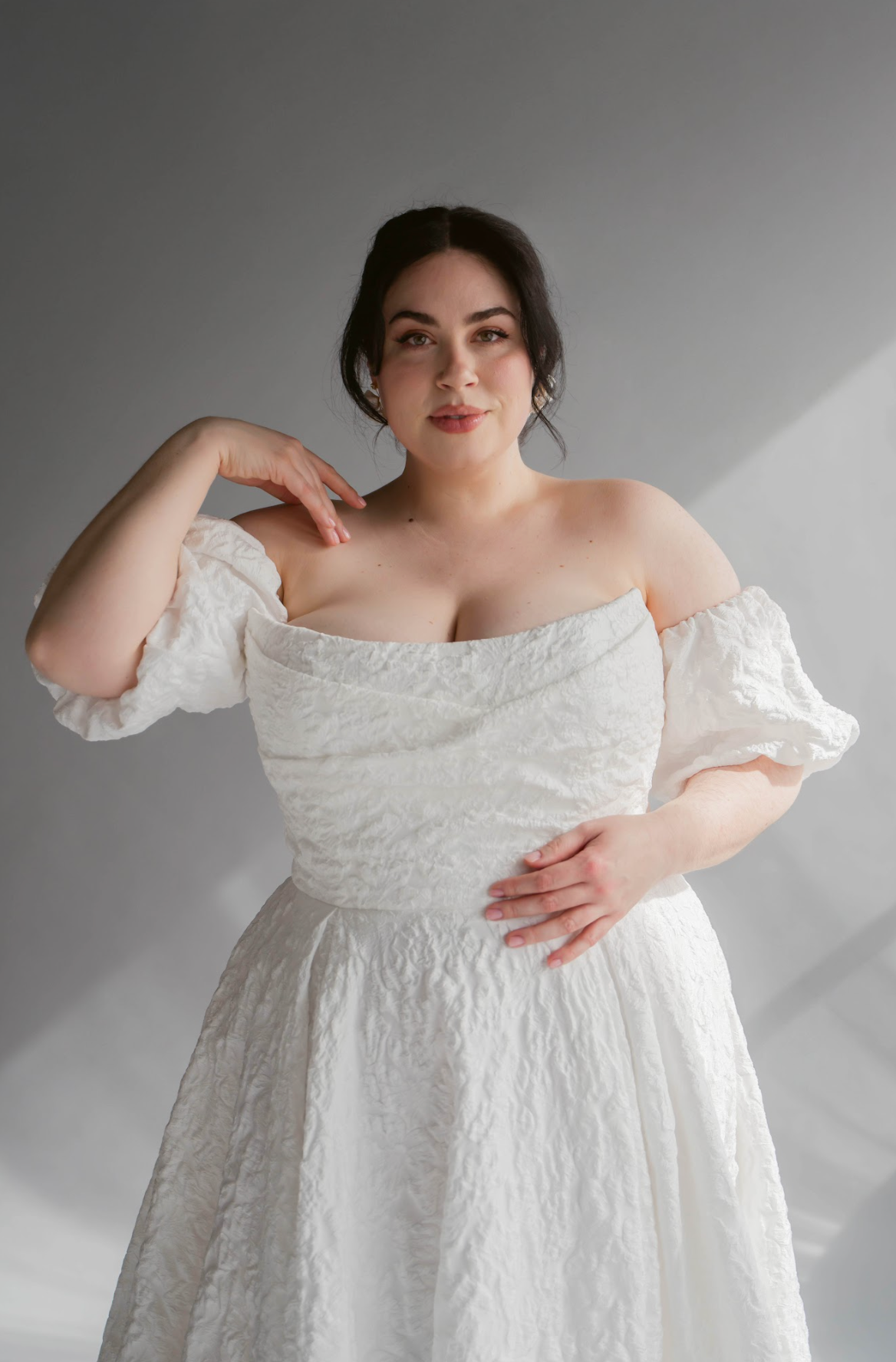 Closeup of the Scooped Puffy Jacquard Neckline of the Lauren Gown. Plus size model with a puff removable sleeve