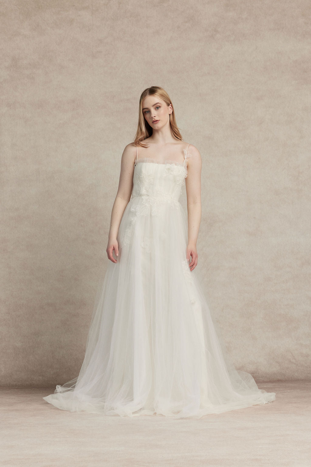strapless A-line gown is crafted in layers of delicate tulle, creating a light and ethereal silhouette. 