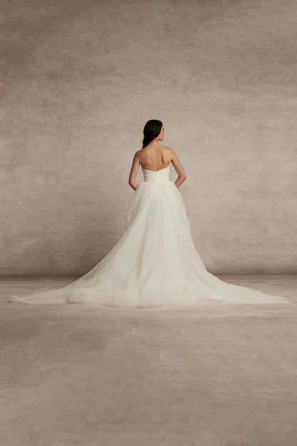 Meet Zara, a pleated tulle romantic ball gown with draped bodice, basque waist and voluminous skirt. Pair her with a gorgeous silk scarf to finish this unique beauty.