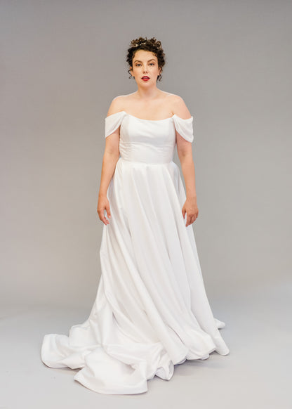 Aline Mikado simple wedding dress shown with Poppy soft off the shoulder drapes