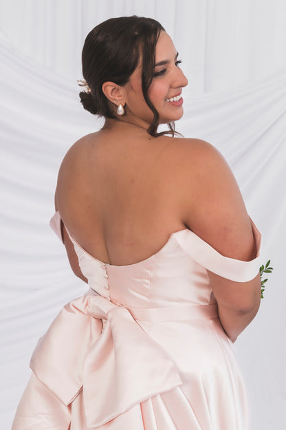 Back View of the Plus Size Wedding Dress with a scooped backline and an oversized bow with satin matching buttons 