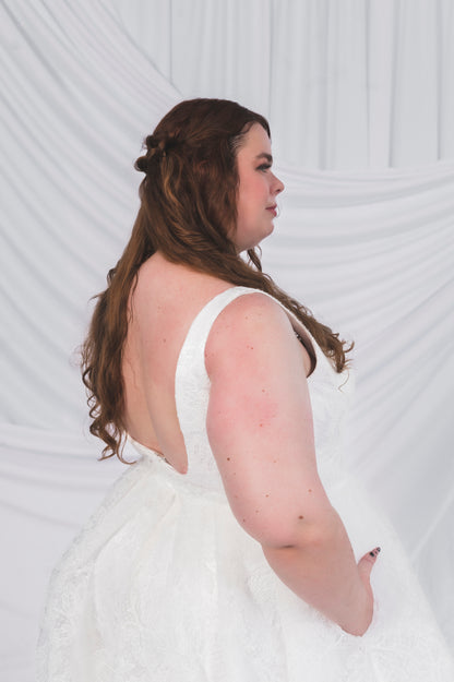 Plus Size Bride in Ottawa wearing the Sierra gown in full lace, which shows off a low back square backline and pockets