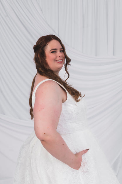 Plus Size Bride in Ottawa wearing the Sierra gown in full lace, which shows off pockets and thick straps