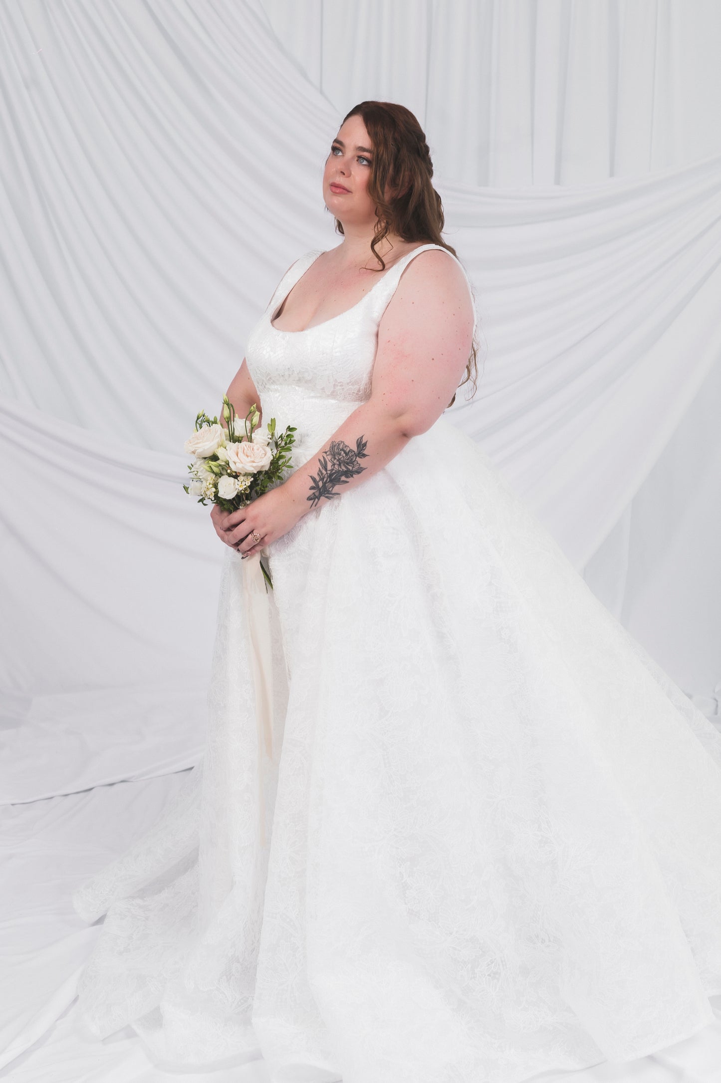 Plus Size Bride in Ottawa wearing the Sierra gown in full lace, which shows off a square neckline and full ballgown skirt
