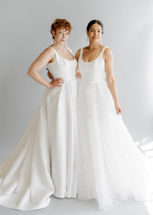 2 models wearing the Sierra a-line dress, one in mikado and one in lace.