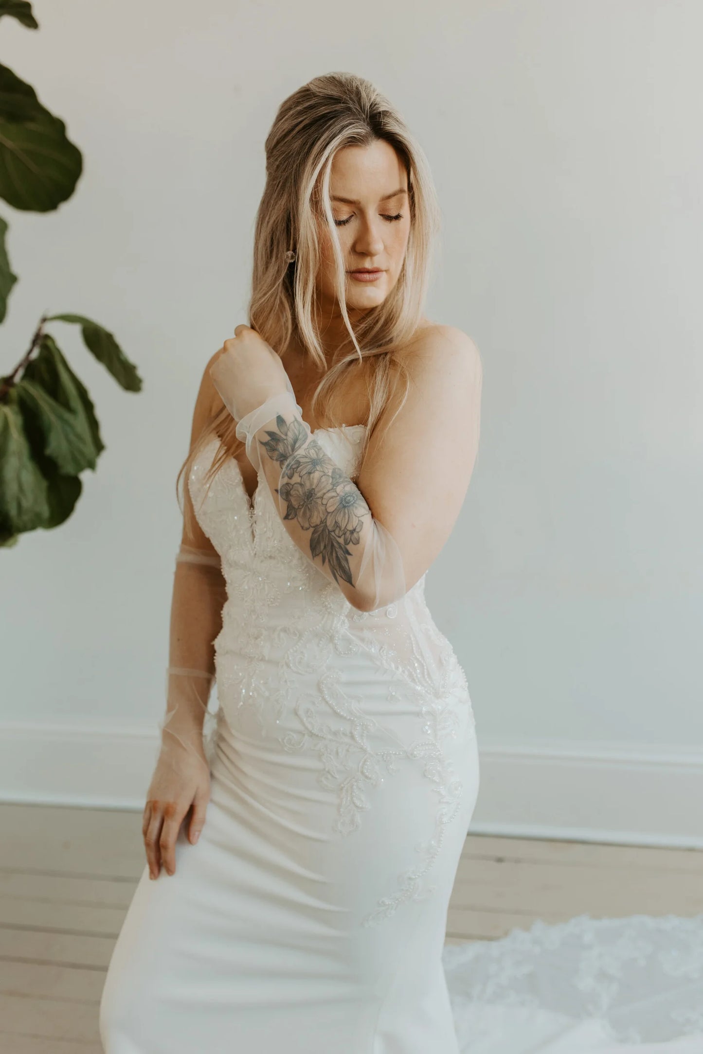 Model wearing a wedding dress and plain tulle sleeves