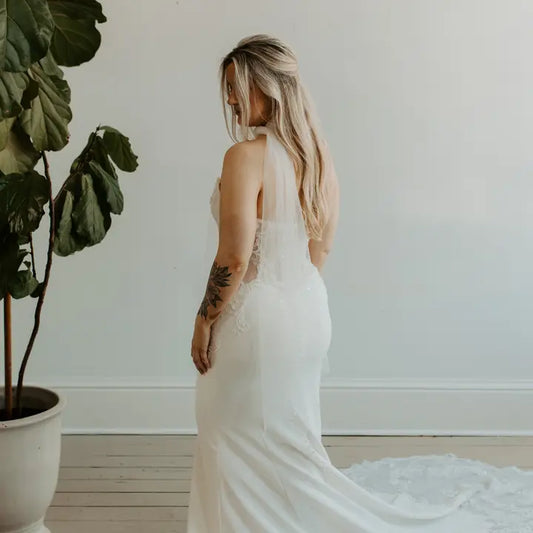 Model in a wedding dress wearing as a scarf