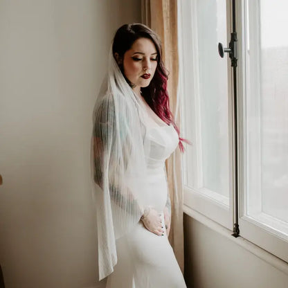 Model wearing the pleated light ivory veil