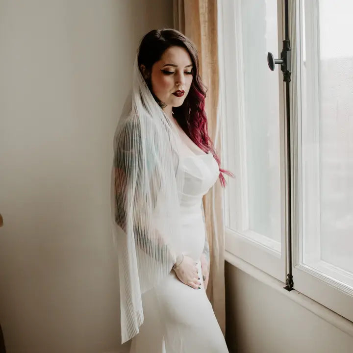 Model wearing the pleated light ivory veil