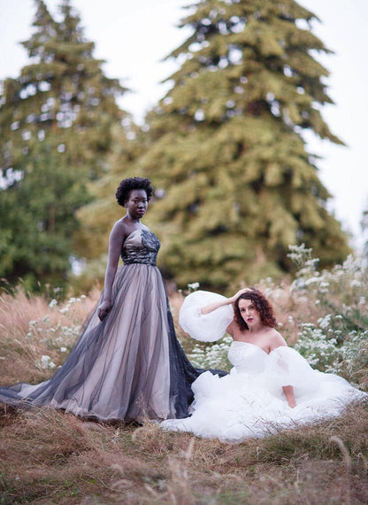 Briar being shown in a garden with both the white with the balloon sleeves and the black wedding dress version
