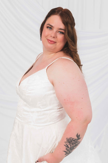 Laura/Tasha wedding dress on a plus size bride for wedding dress shopping ottawa. A-line textured wedding dress with v-neck, straps, and wedding gown pockets