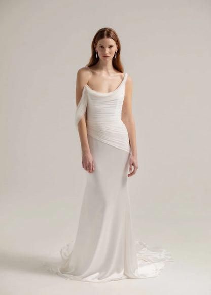 This fit and flare triacetate gown stuns with a luxurious silk tulle overlay, and asymmetrical shoulder detail.