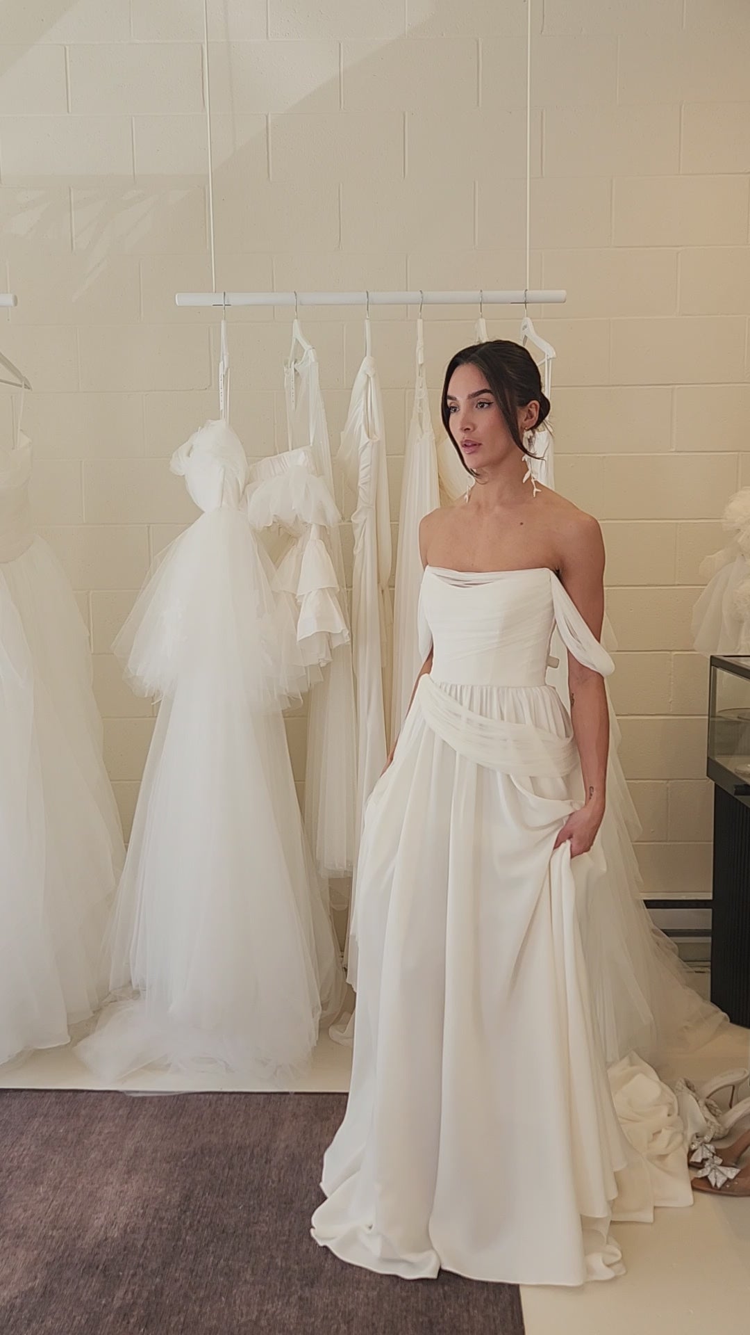 Model wearing the sora Aline gown from ouma. Soft scoop neckline, silk tulle draped features and removable sleevees 