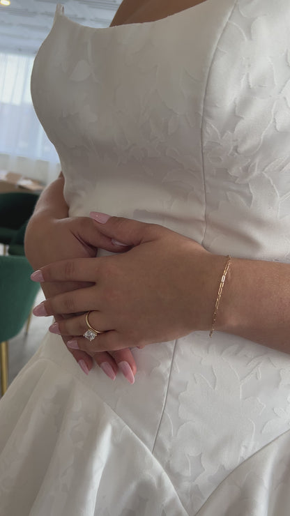 closeup of the cotton burnout fabric, ivory with a floral pattern