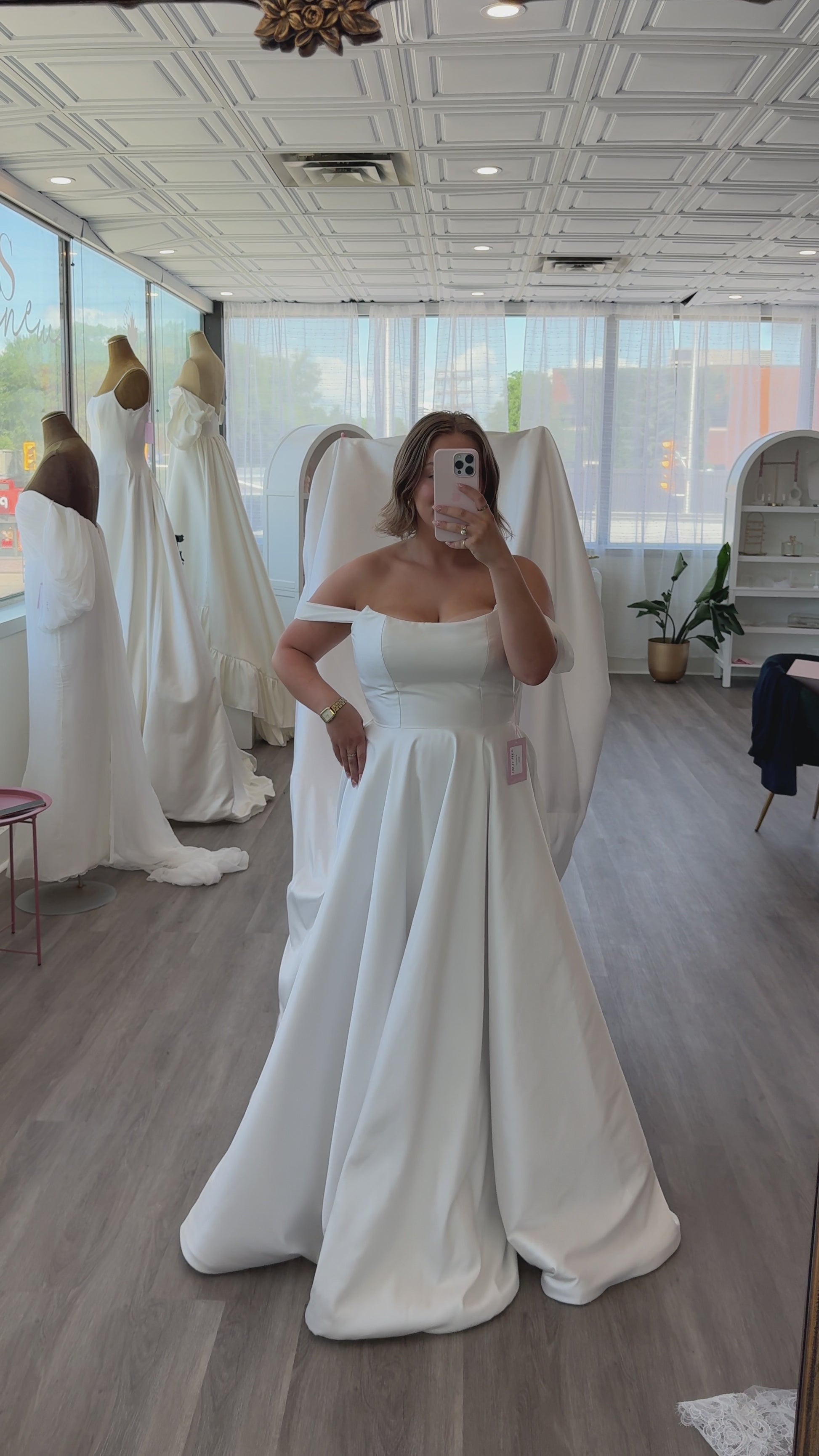 The train fluff of the Poppy Clara Dress, Shown in bridal size 10 with a soft cat eyeline fitted bodice with a mikado aline skirt