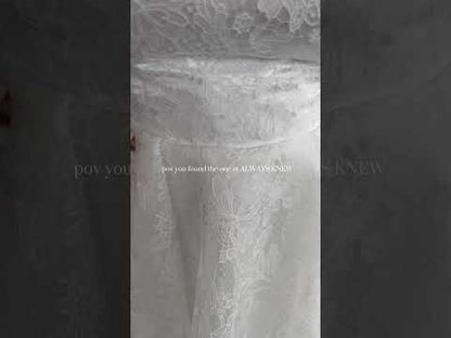 closeup of the sierra gown on a size 22 bride in front of all plus size and standard size gowns