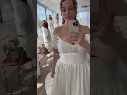 Closeup of the hazel gown. Ivory Mikado Ballgown Aline Dress with a thick waistband and puff off the shoulder sleeves